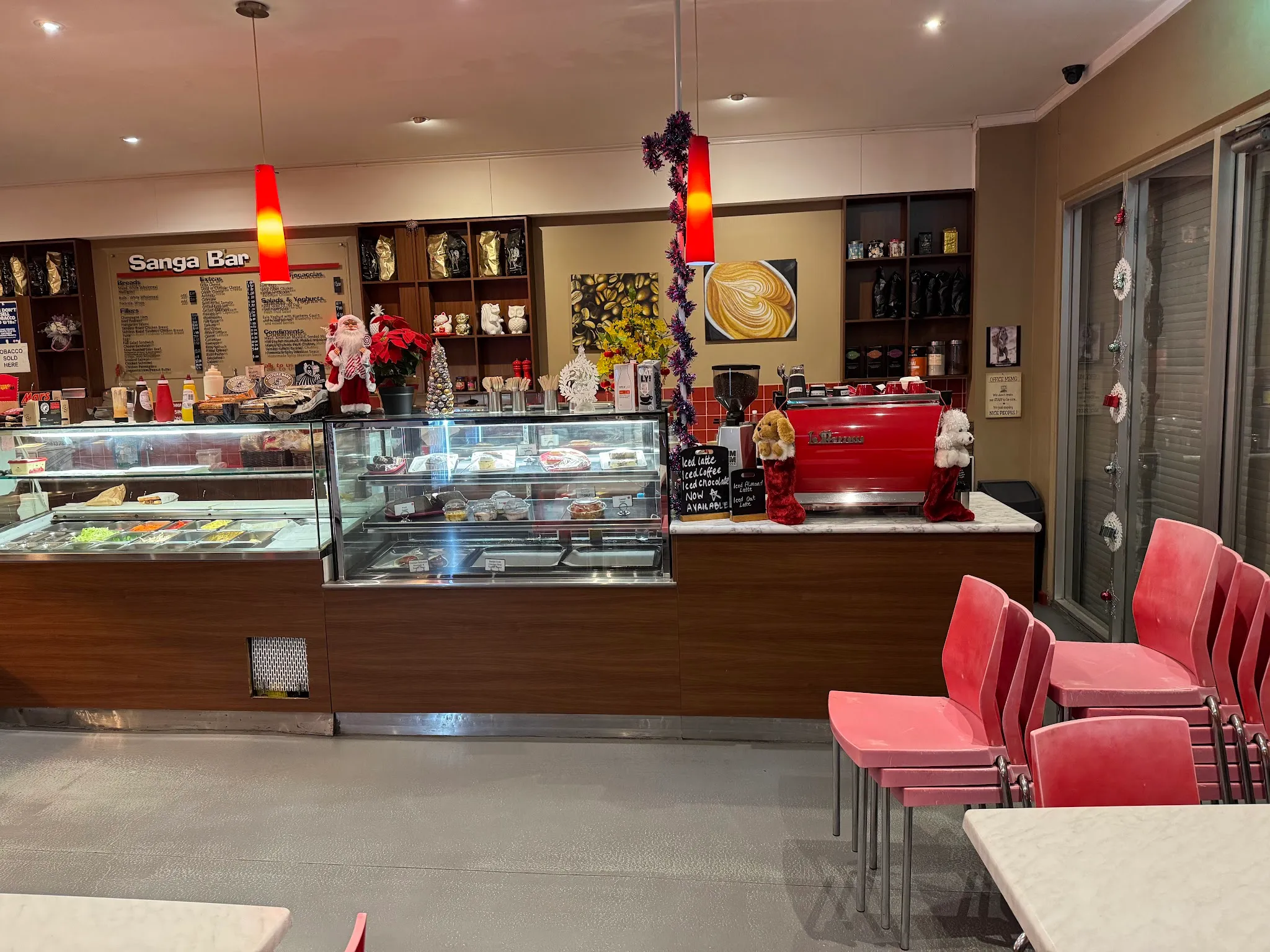 Cafe counter with the red espresso machine and warm pendant lighting
