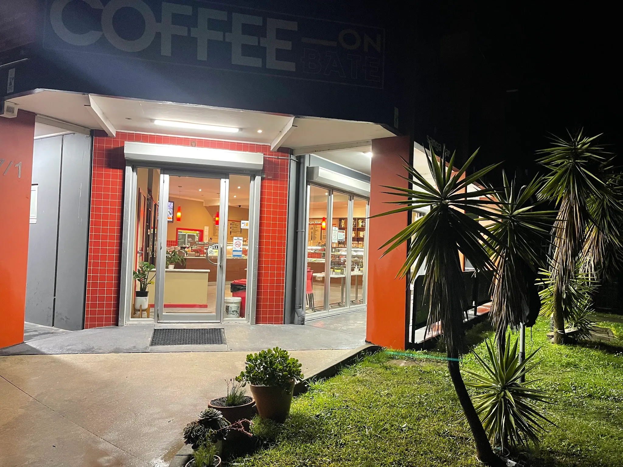 Coffee On Bate entrance lit up at night