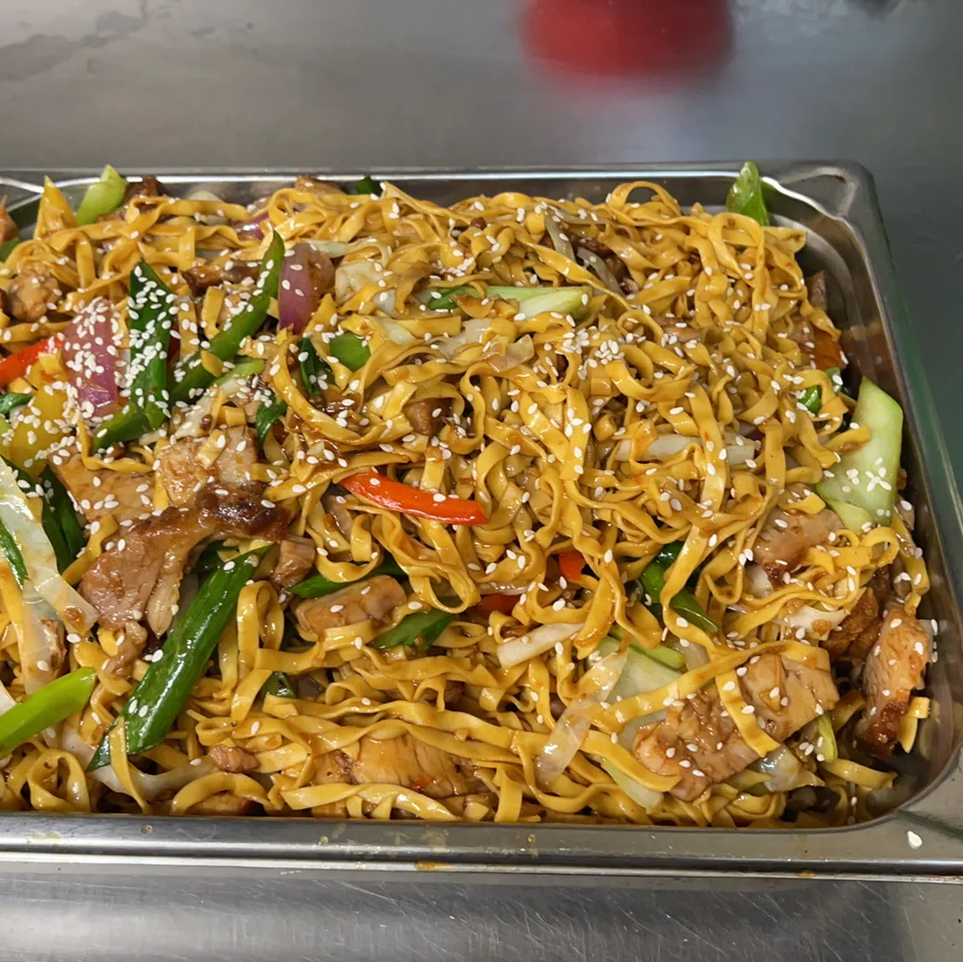 Tray of stir-fried hokkien noodles with pork and vegetables