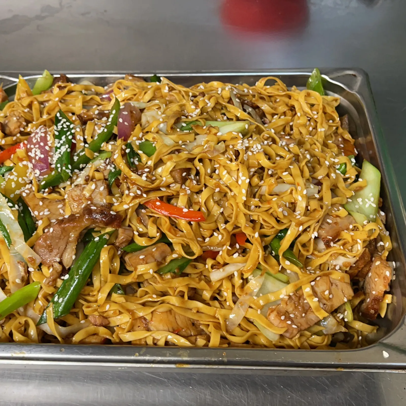 Tray of stir-fried hokkien noodles with pork and vegetables