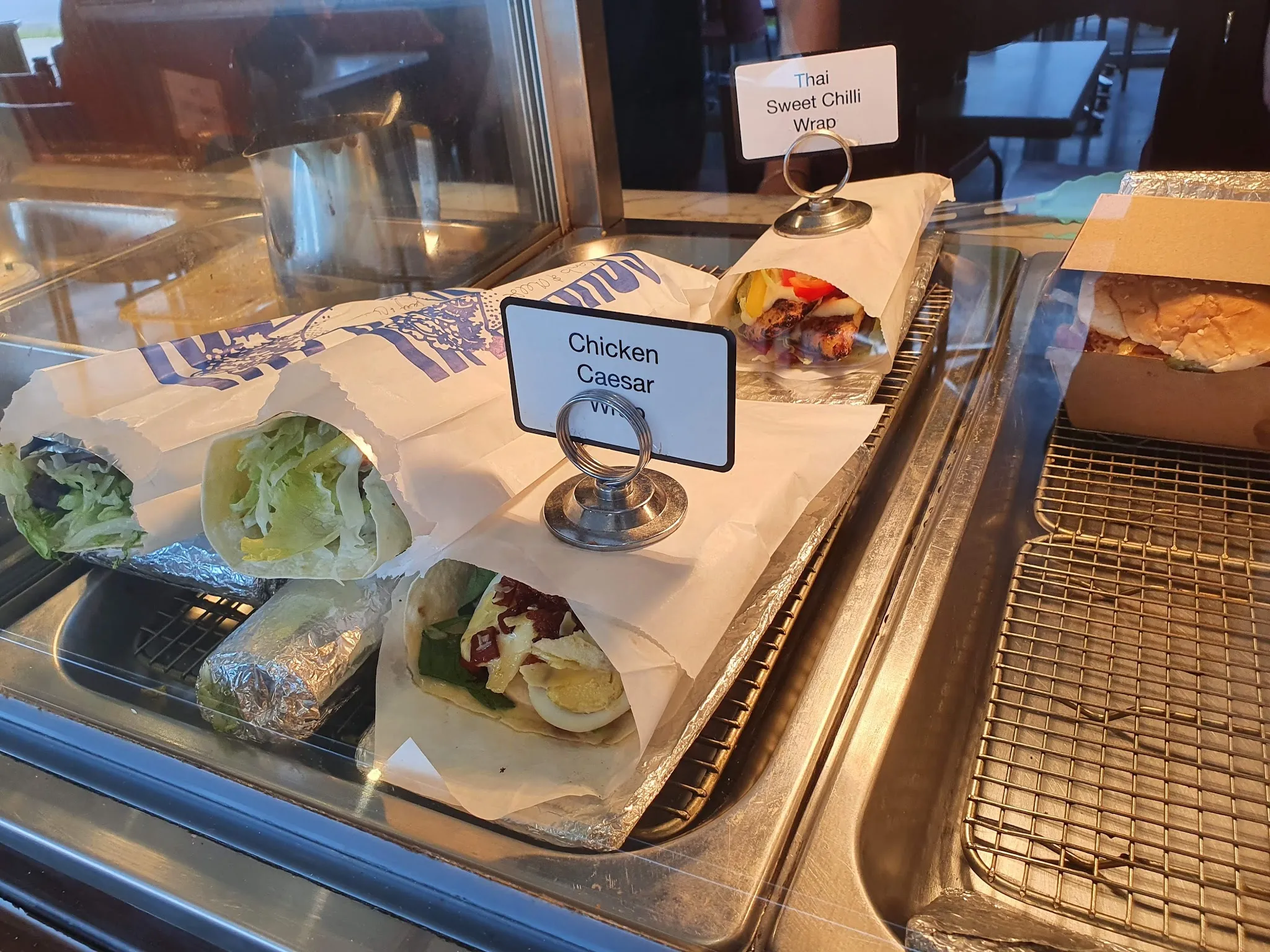 Chicken Caesar and Thai sweet chilli wraps in display cabinet