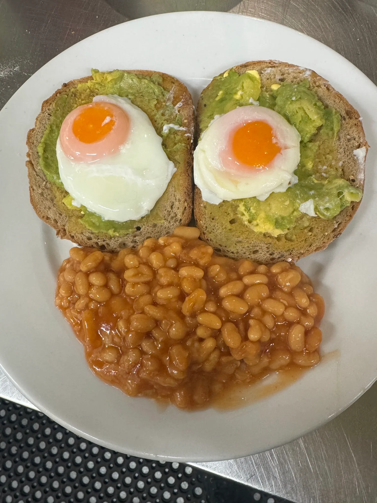 Avocado toast with poached egg and a side of baked beans